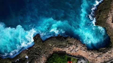 Top Down aerial shot of deep blue waves rolling into Devil's Tears, Bali Stock Footage 319499838