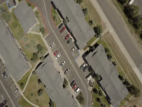 Top down aerial shot of a empty road next to a car park Stock Footage 77656856