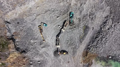 Top down aerial shot of granite gravel piles and machinery Stock Footage 338221908