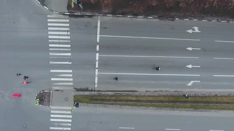 Top down aerial shot of group of people running marathon on empty road Stock Footage 106060122