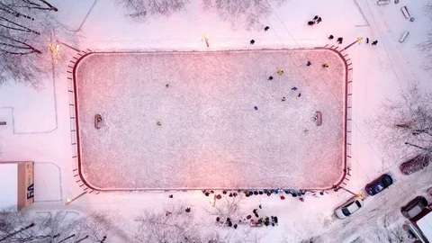 Top-down aerial shot of ice rink and young players in hockey game Stock Footage 85325761