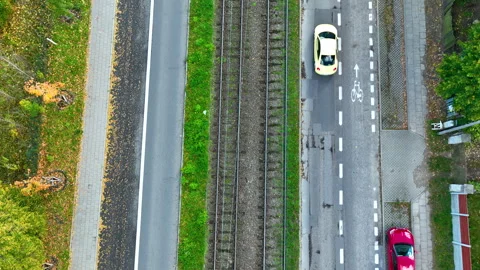 Top-down aerial shot of parallel tram tracks, roads, and bike lanes in Gdańsk Stock-Footage 320937916