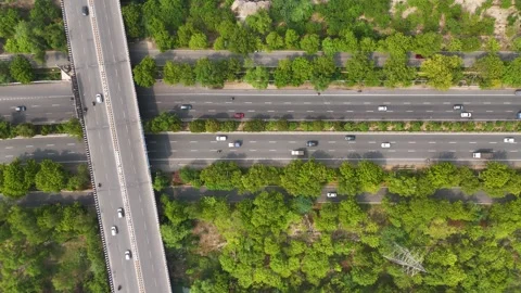 Top-down aerial shot showing a single car driving along an empty desert road. Stock Footage 312487501