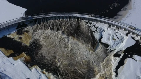 Top down aerial of slow motion water through hydro electric dam Stock Footage 123383513