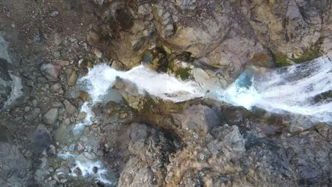 Top-down aerial slow motion shot of a mountain waterfall Stock Footage 337538204