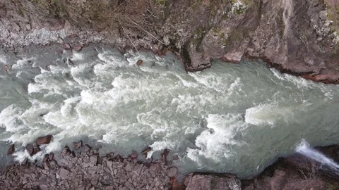 Top-down aerial slow motion view of a turbulent mountain river Stock Footage 337542802