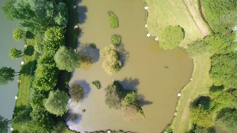 Top down Aerial track of lakes and trees showing water and vegetation Video stock 94138468