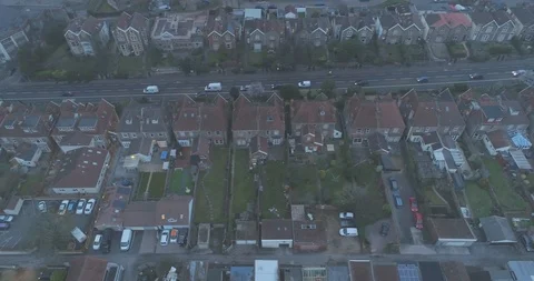 Top down aerial tracking along residential houses gardens and garages beside Stock Footage 108043331