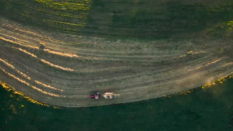 Top-Down Aerial Of Tractor Pulling Baling Machine In In Rural Stock Footage 165256463