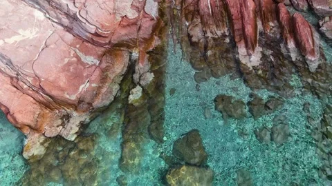 Top Down Aerial Video of a Layered Red Rock Seabed in Clear Water Stock Footage 317206305