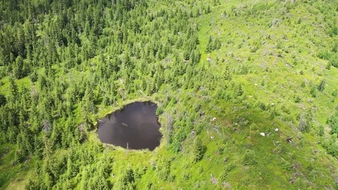 Top down aerial video of small mountain blind lake Stock Footage 114297978