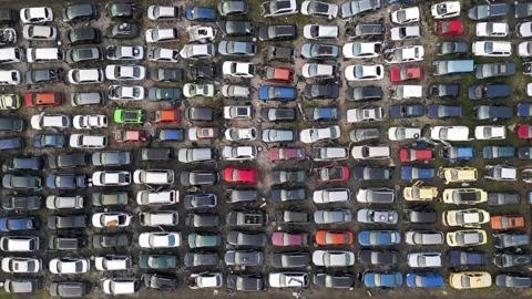 Top down aerial view of an abandoned car graveyard filled with old, damaged and Stock Footage 323442200