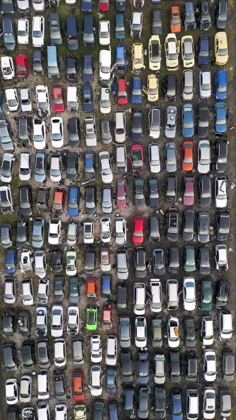 Top down aerial view of an abandoned car graveyard with hundreds of old, damaged Stock Footage 323442526