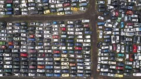 Top down aerial view of an abandoned car graveyard with hundreds of old, damaged Stock Footage 323442857