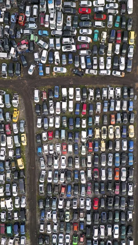 Top down aerial view of an abandoned car graveyard with hundreds of old, damaged Stock Footage 323443046