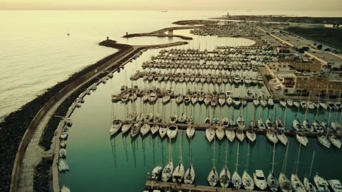 Top down aerial view above luxury yachts parked on turquoise ocean water marina Stock Footage 232923523