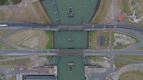Top down aerial view of the Afsluitdijk at the Lorentz Locks with road traffic Stock Footage 343839449
