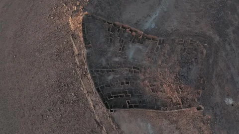 Top-Down Aerial View of Ancient Stone Ruins Layout in Desert Stock Footage 336025349