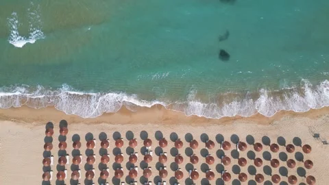 Top Down Aerial View of Beach Umbrellas on Sandy Coast and Sea Stock Footage 340391427