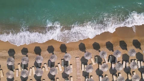 Top Down Aerial View of Beach Umbrellas on Sandy Coast and Sea Vídeos de archivo 340391530