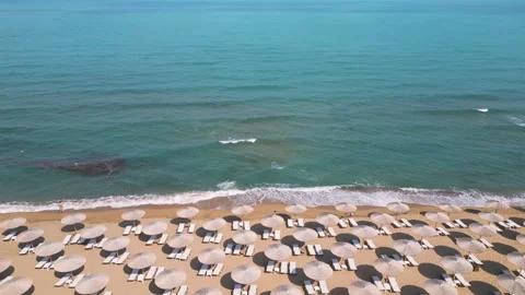 Top Down Aerial View of Beach Umbrellas on Sandy Coast and Sea Video stock 340391568