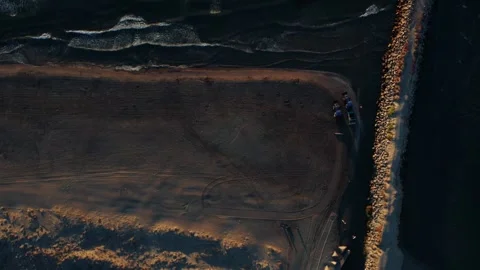 Top Down Aerial View of Beach and Breakwater at Sunset Stock Footage 344529218
