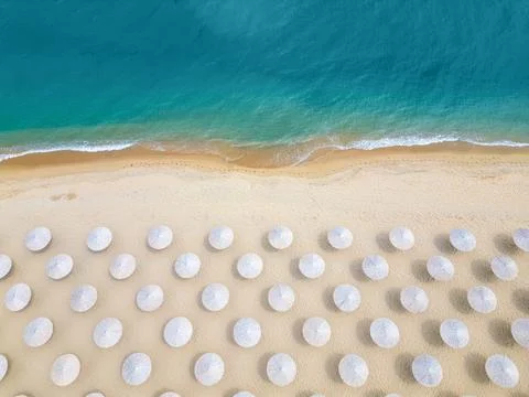 Top Down Aerial View of Beach Umbrellas on Sandy Coast and Sea Stock Photos