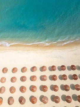 Top Down Aerial View of Beach Umbrellas on Sandy Coast and Sea Stock Photos