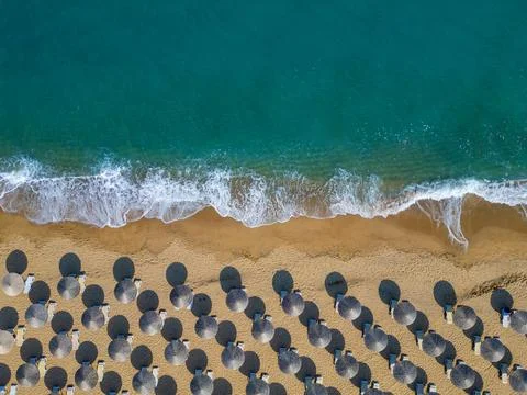 Top Down Aerial View of Beach Umbrellas on Sandy Coast and Sea 写真素材