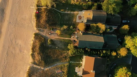 Top down Aerial view of beachfront houses. Establishing shot of waterfront homes Stock Footage 163143052