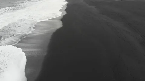 Top down aerial view on a black beach with white waves in Iceland Stock Footage 103381185