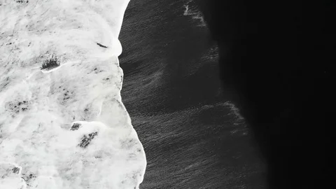 Top down aerial view on a black beach with white waves in Iceland Stock Footage 103381286