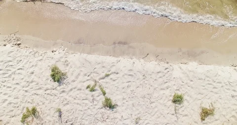 Top-down aerial view of Black Sea water waves meet the white sand beach dunes in Stock Footage 105043887
