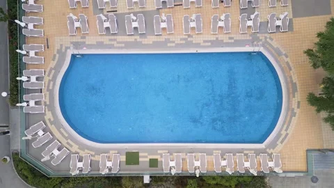 Top Down Aerial View of Blue Hotel Swimming Pool with Sunbeds Stockbeeldmateriaal 347066717