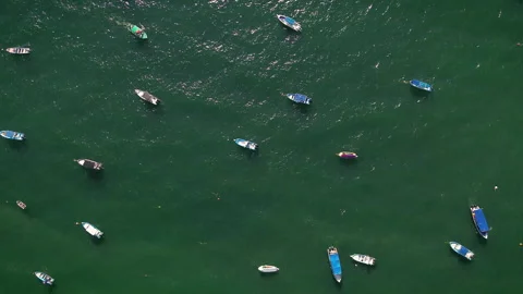 Top down aerial view of boats floating on calm water at Los Muertos Beach Видео 346192518