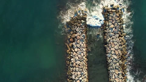 Top-Down Aerial View of a Breakwater in Calm Sea Video stock 326972248
