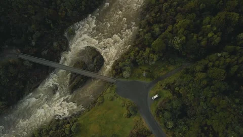 Top down aerial view of bridge above a wide river with a van camping in the.. Stock Footage 288503348