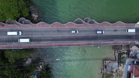 Top down aerial view of bridge with cars and motorbikes crossing in Patong 動画素材 332713244
