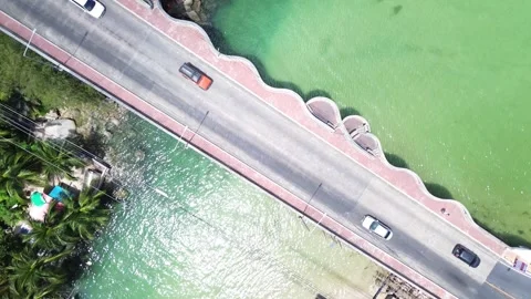 Top down aerial view of bridge with cars and motorbikes crossing in Patong 動画素材 332713299