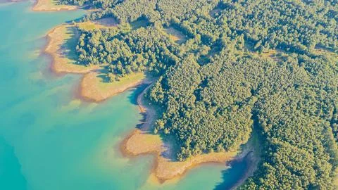 Top down aerial view of bright turquoise water of Lake Plastiras meeting de.. Stock Photos