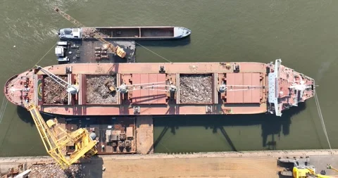 Top down aerial view on a bulk carrier being loaded at the port. Stock Footage 243435104