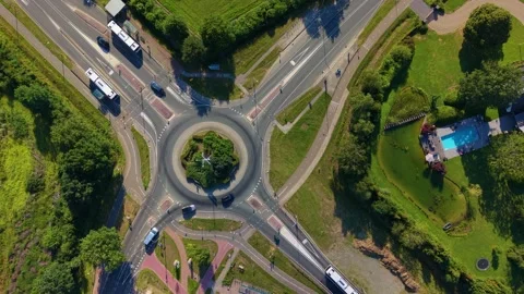 Top-down aerial view of a busy roundabout with cars, trucks and buses Stock Footage 339371630
