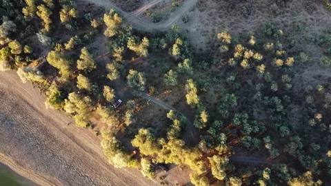 Top down aerial view of campsite with tents and 4x4 car in riverside forest Stock Footage 335080162