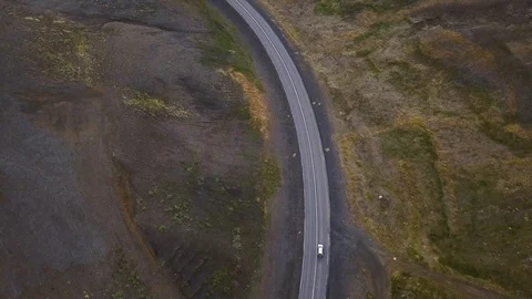 Top down aerial view of car driving on empty road in Iceland Stock Footage 120144470