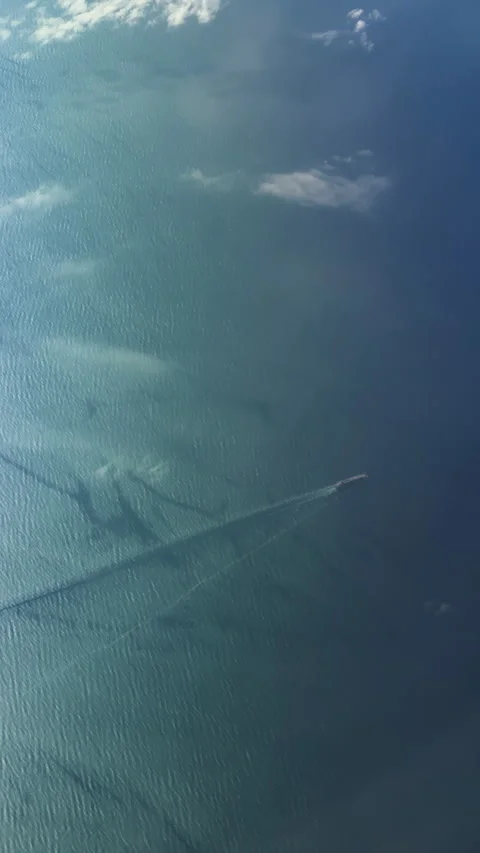 Top-down aerial view of cargo ship with cloud shadows on ocean water Stock Footage 345168864