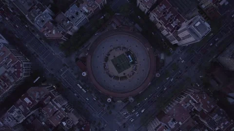 Top down aerial view of circular arena and city streets at dusk Stock Footage 343538462