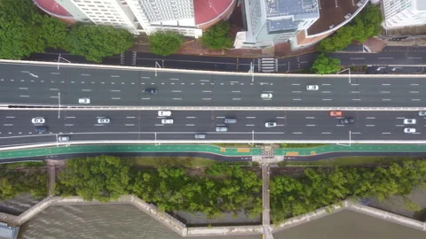 Top down aerial view of city street traffic and riverbank Stock Footage 345155549