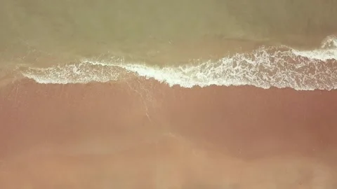Top-down aerial view of a clean white sandy beach on the shores of a beautiful Video stock 138489908