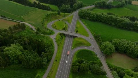 Top-down aerial view of a clean, modern road interchange integrated into the 库存影片 335721021