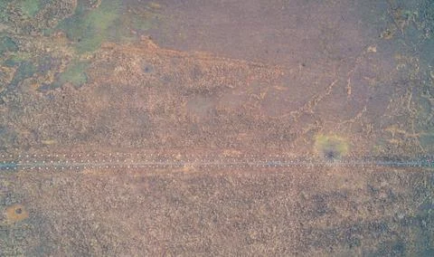 Top down aerial view of concrete dragons teeth anti tank defensive line in dry Stock Photos